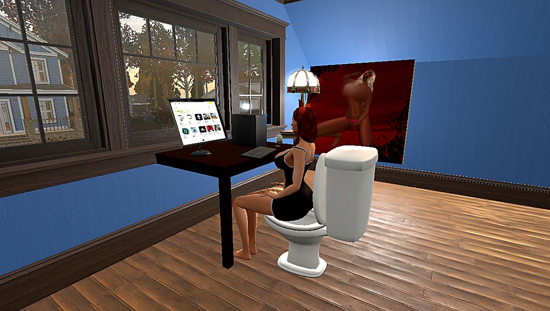 Roxy in her trailer, next to a toilet and a computer.
